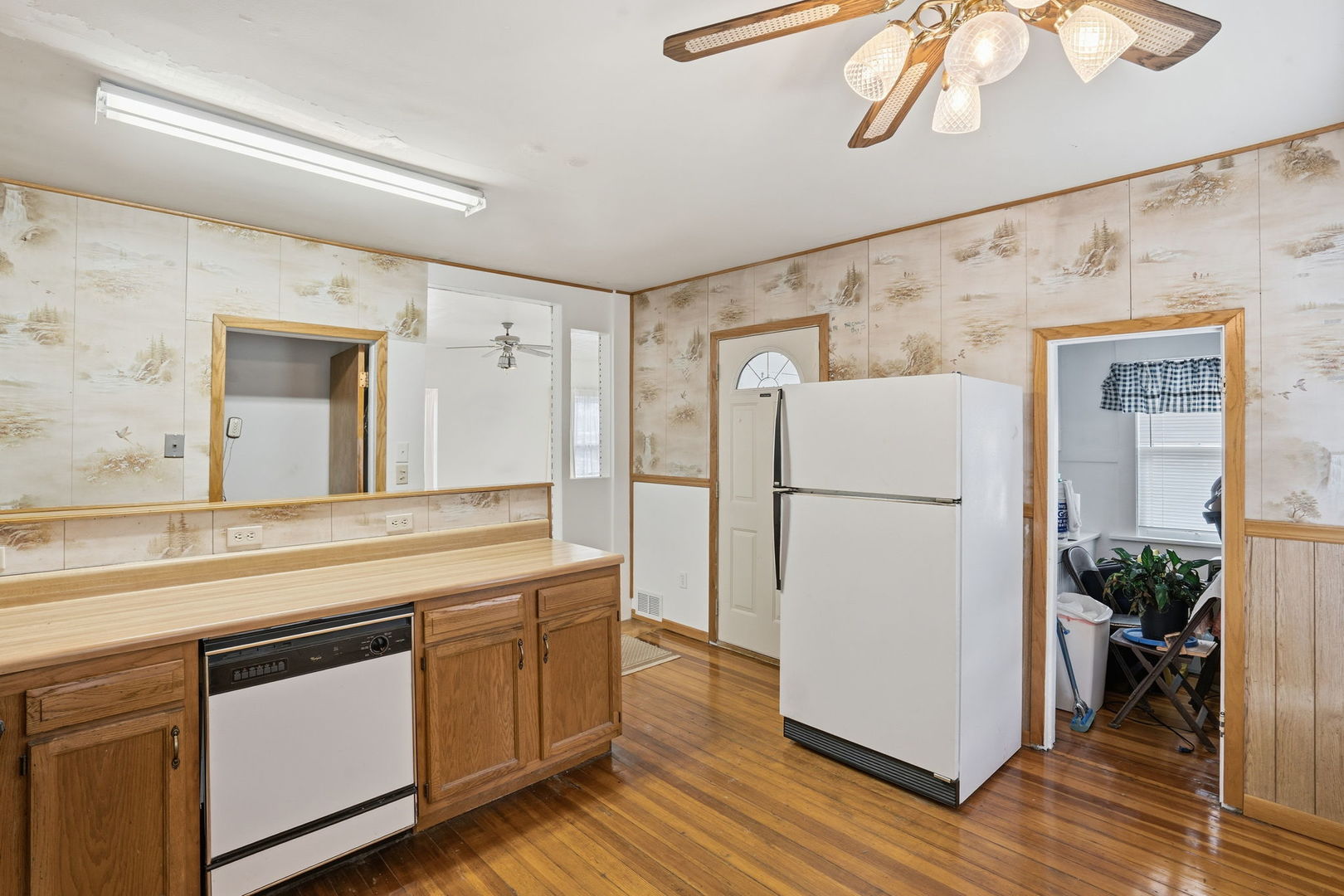 411 39th Street Moline, IL 61265 - Photo 8 of 16 a kitchen with stainless steel appliances a refrigerator and a wooden floor