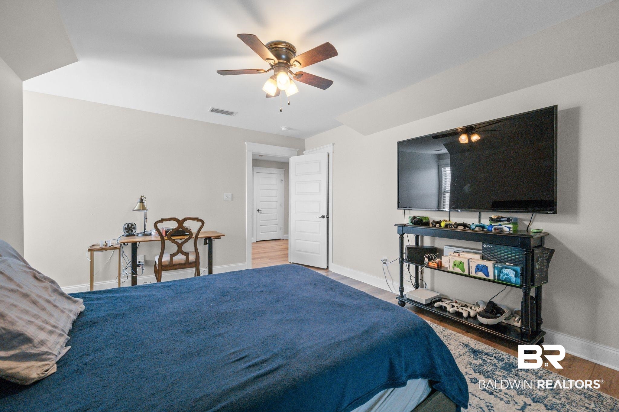 409 Fortune Drive Fairhope, AL 36532 - Photo 29 of 42 Spacious room featuring light-toned walls, wood-finish flooring, and a ceiling fan with integrated lighting