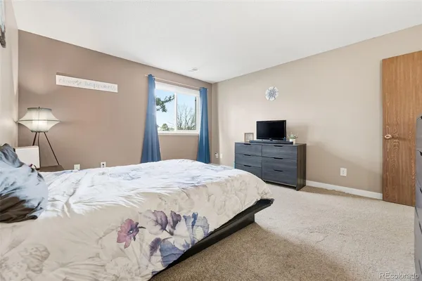 a bedroom with a bed and a tv