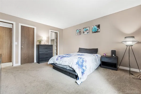 a spacious bedroom with a bed and a table