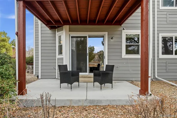 a balcony with furniture and wooden floor