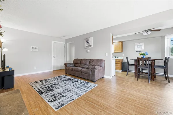 a living room with furniture and wooden floor