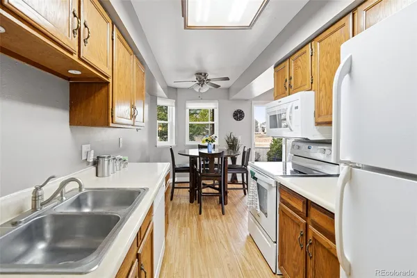 a kitchen with stainless steel appliances granite countertop a sink a stove and cabinets