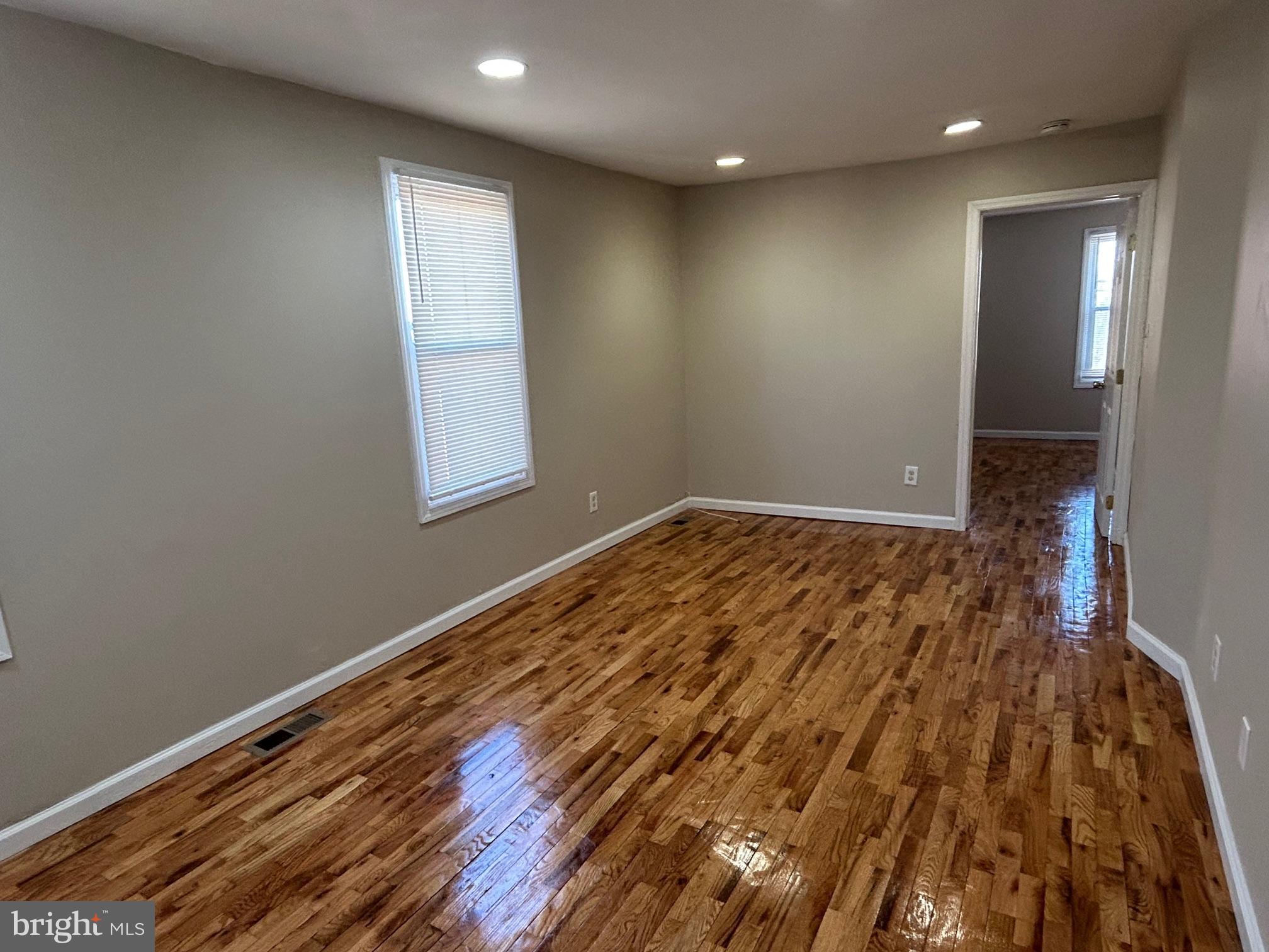 47 B Hanover Street Pemberton, NJ 08068 - Photo 2 of 6 an empty room with wooden floor and windows