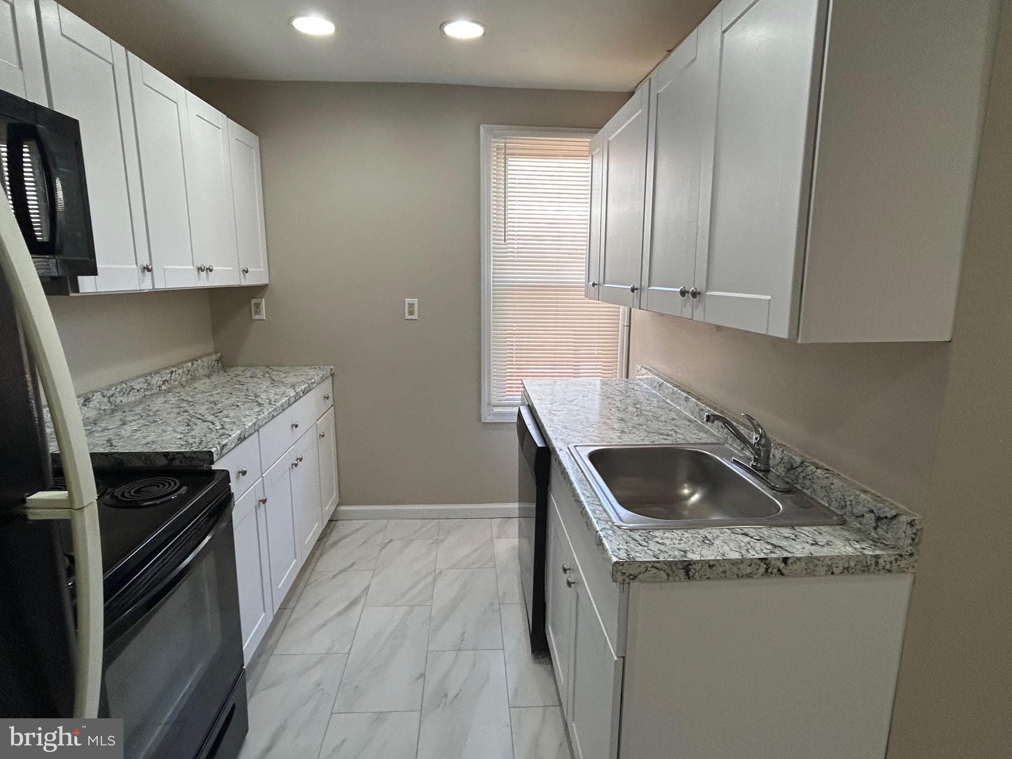 47 B Hanover Street Pemberton, NJ 08068 - Photo 3 of 6 a kitchen that has a sink and a stove