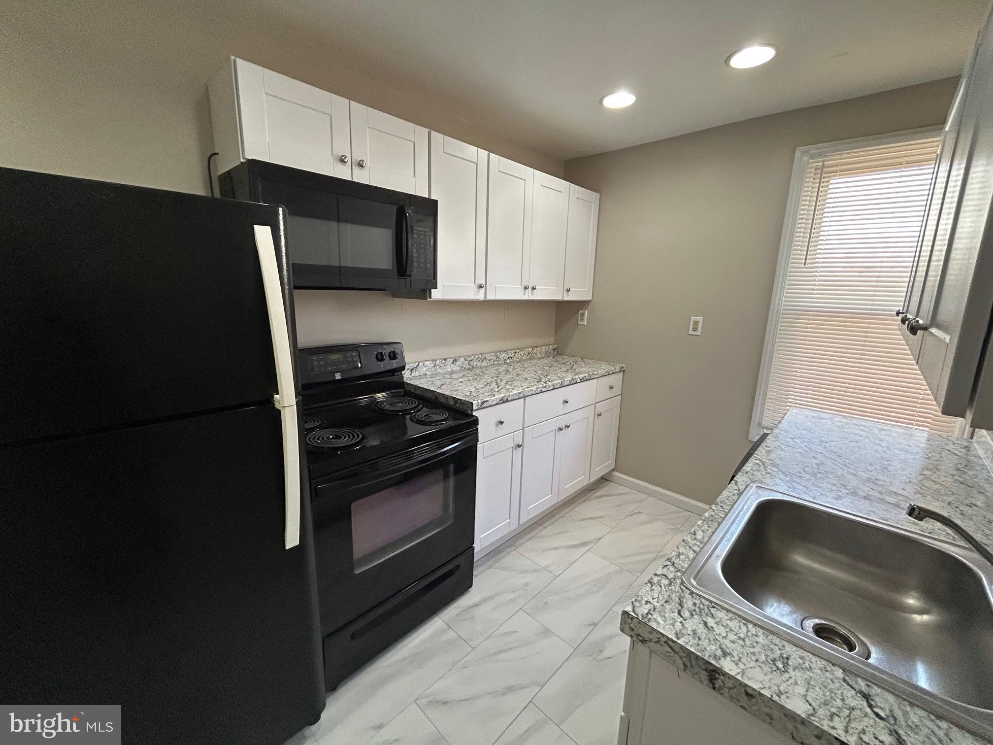 47 B Hanover Street Pemberton, NJ 08068 - Photo 4 of 6 a kitchen with granite countertop a sink stove and refrigerator