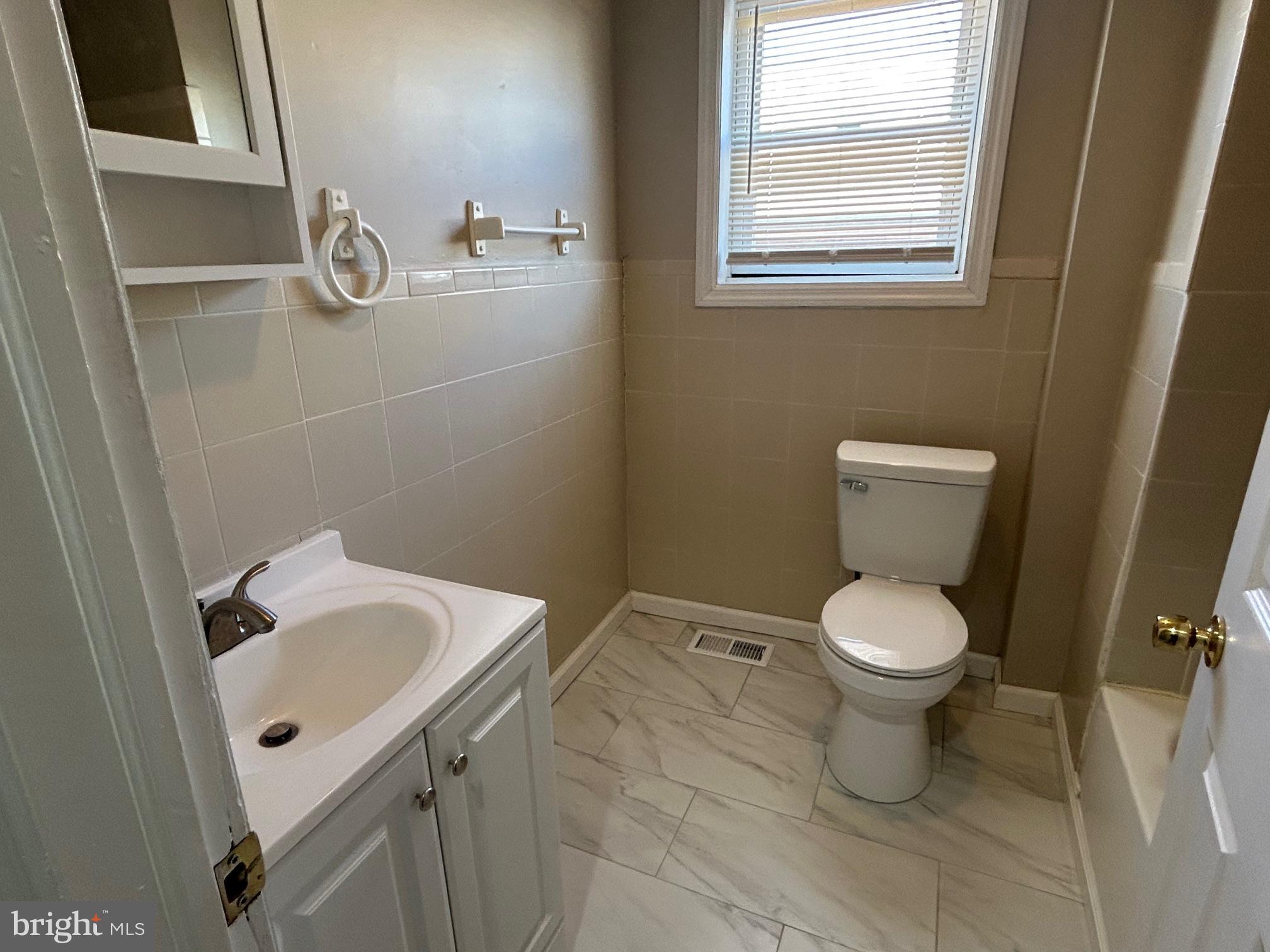 47 B Hanover Street Pemberton, NJ 08068 - Photo 6 of 6 a white toilet sitting next to a bathroom sink