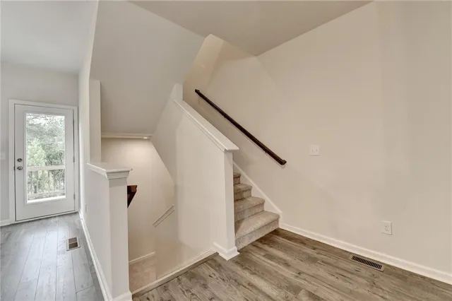 a view of entryway with wooden floor and stairs