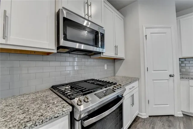 a kitchen with a stove and a microwave