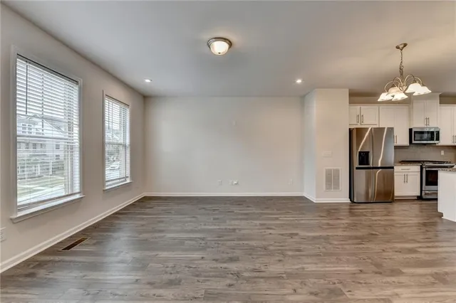 a view of a kitchen with an entryway and a window
