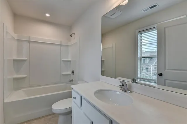 a bathroom with a sink toilet tub and shower