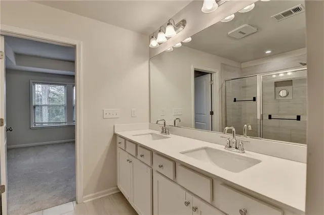 a bathroom with a sink double vanity and a mirror