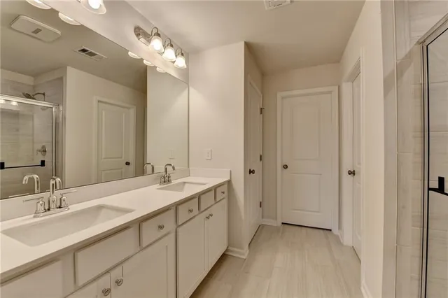 a bathroom with a double vanity sink mirror and