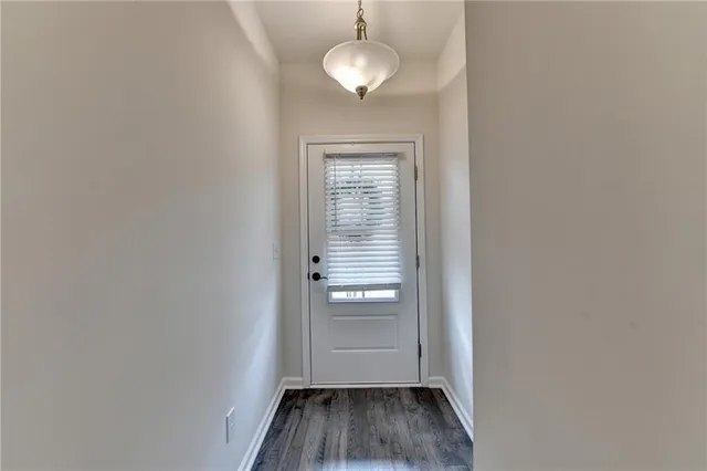 a view of a room with wooden floor and a ceiling fan