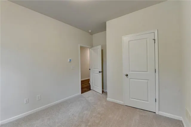 a view of an empty room with closet area