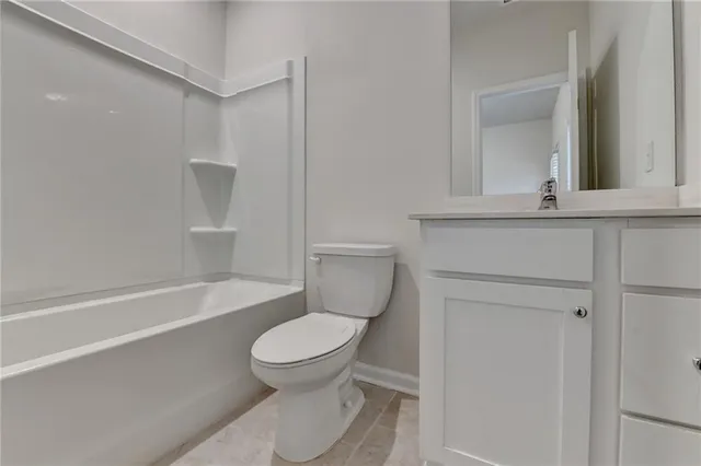 a bathroom with a toilet a sink and bathtub