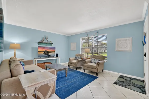a kitchen with white cabinets and sink