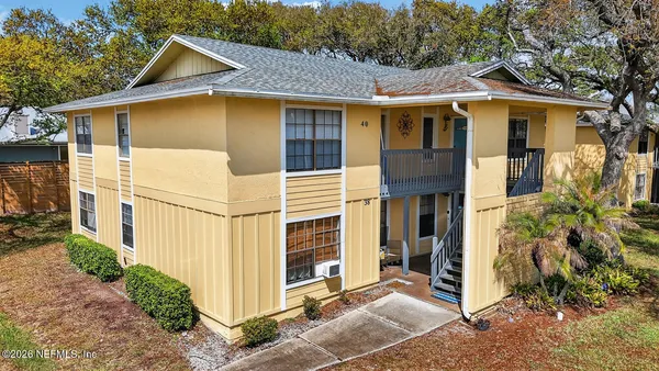aerial view of a house with yard and mountain view in back