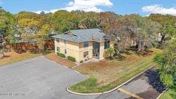 an aerial view of residential houses with outdoor space