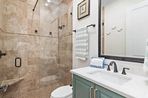 a bathroom with a sink toilet and shower
