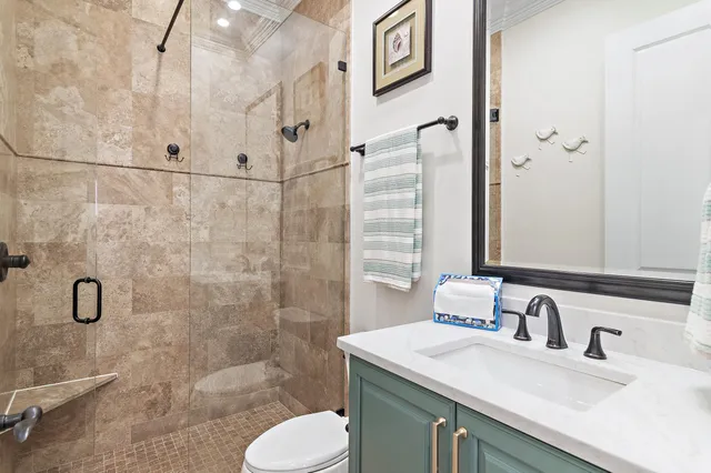a bathroom with a sink toilet and shower