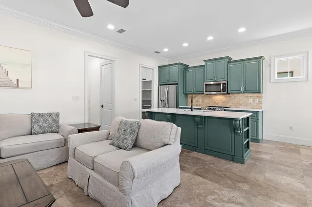 a living room with furniture and a kitchen