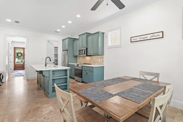 a open kitchen with stainless steel appliances granite countertop a stove refrigerator and a sink