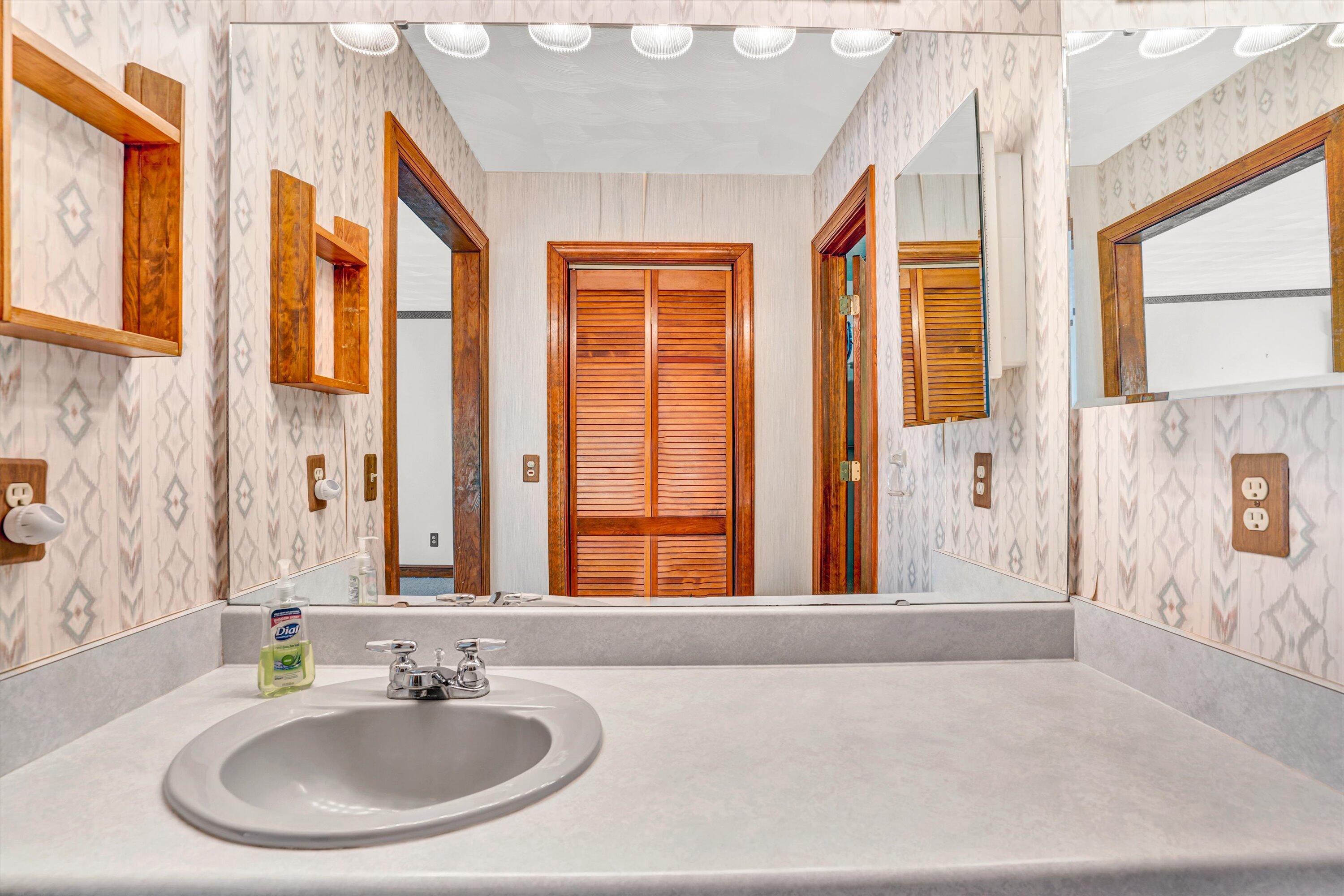 551 Heather Ridge Drive Rocky Mount, VA 24151 - Photo 19 of 41 a bathroom with a sink and a large mirror
