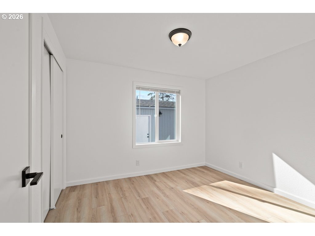 11201 Northwest 3rd Avenue Vancouver, WA 98685 - Photo 13 of 21 a view of an empty room with wooden floor and a window