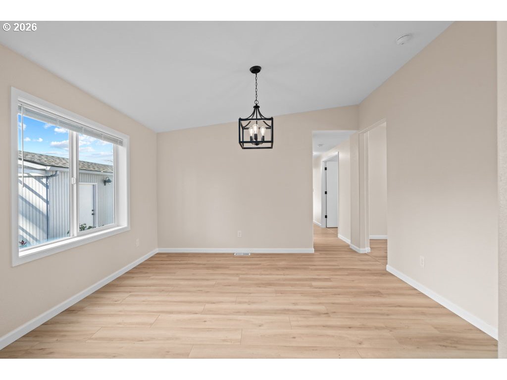 11201 Northwest 3rd Avenue Vancouver, WA 98685 - Photo 7 of 21 a view of an empty room with window and wooden floor