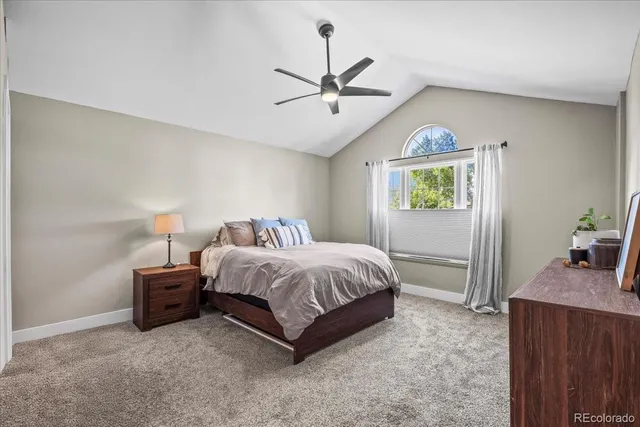 a spacious bedroom with a bed and a window