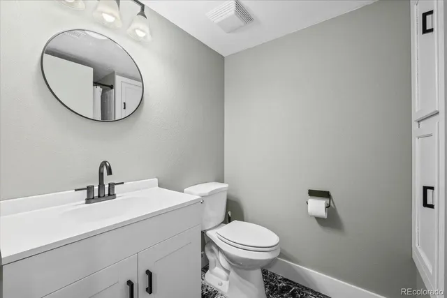a bathroom with a sink a mirror and a toilet