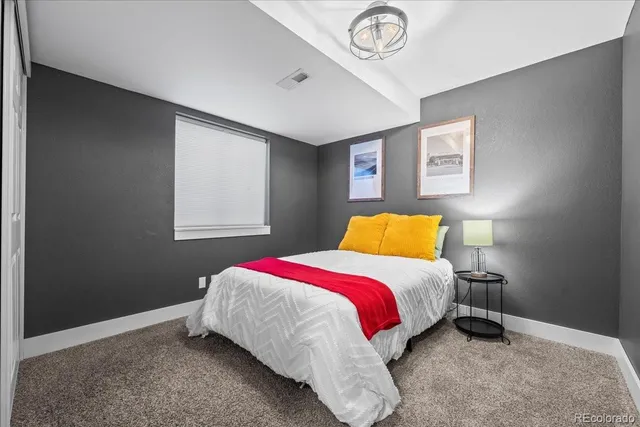 a bed room with a bed and a window