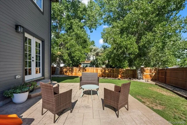 a view of a patio with couches chairs and a potted plant