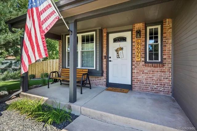 a view of a house with backyard and sitting area