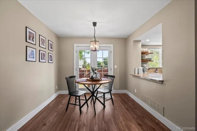 a dining room with furniture window and wooden floor
