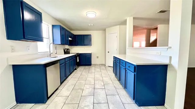 a large kitchen with a wooden floor and cabinets