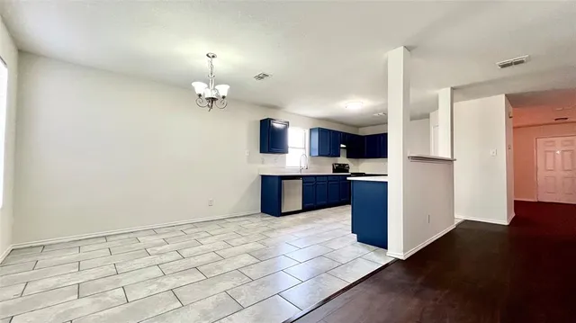 a kitchen with kitchen island white cabinets and stainless steel appliances