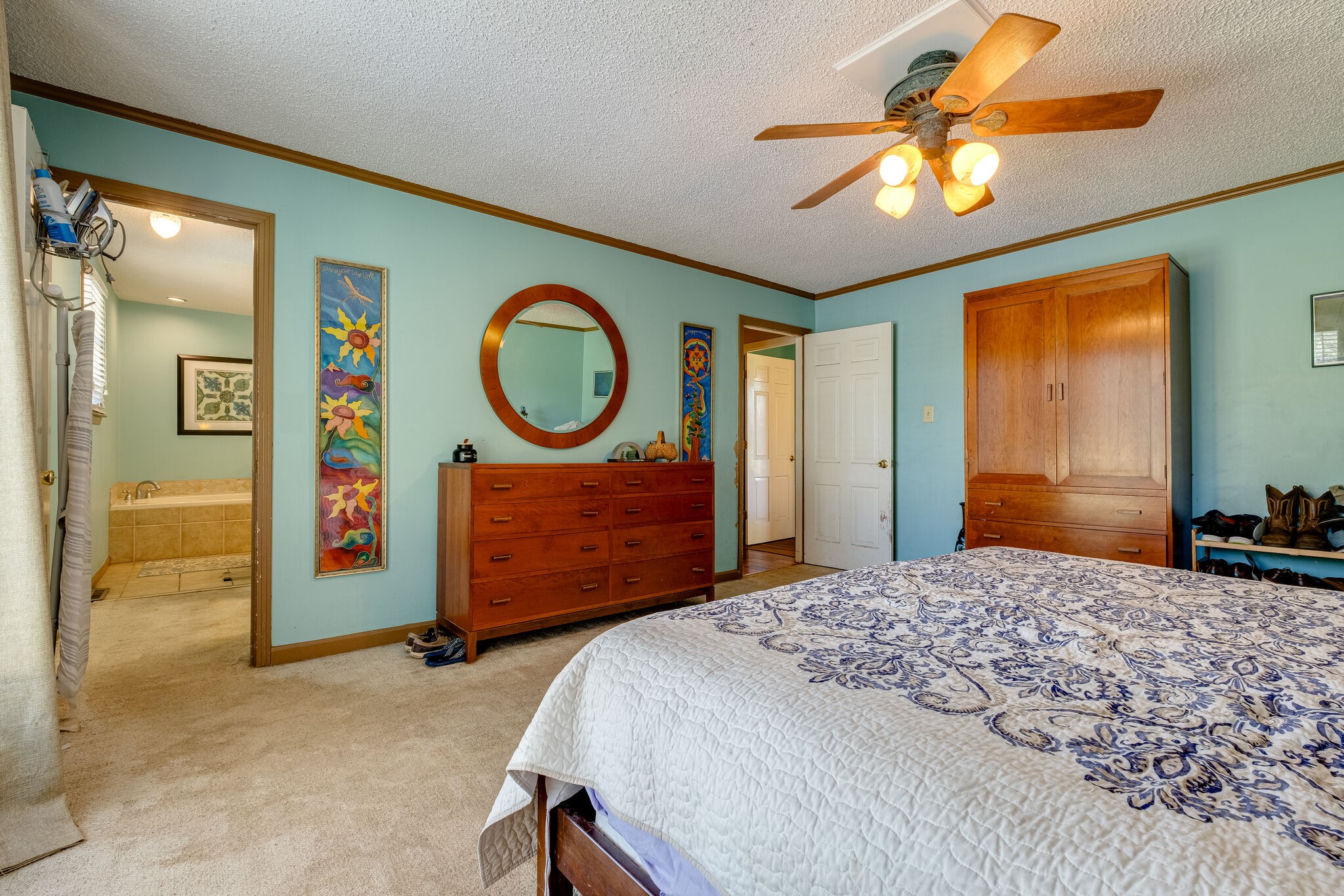 5025 Hickory Ridge Road Lebanon, TN 37087 - Photo 20 of 52 a bedroom with a bed a dresser and painting on the wall