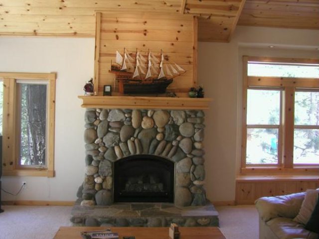 14801 Tyrol Road Truckee, CA 96161 - Photo 2 of 7 a living room with fireplace furniture and a window