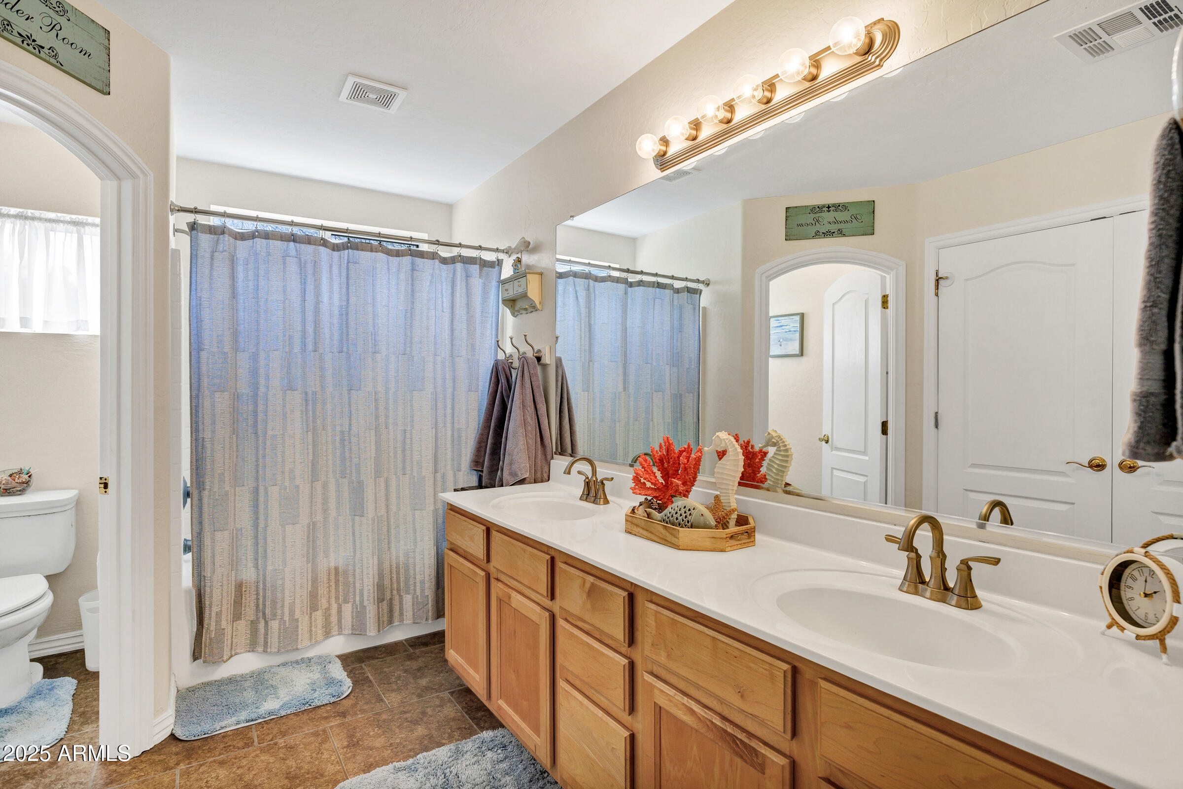 2864 East Pony Court Gilbert, AZ 85295 - Photo 12 of 20 a bathroom with a double vanity sink and a mirror