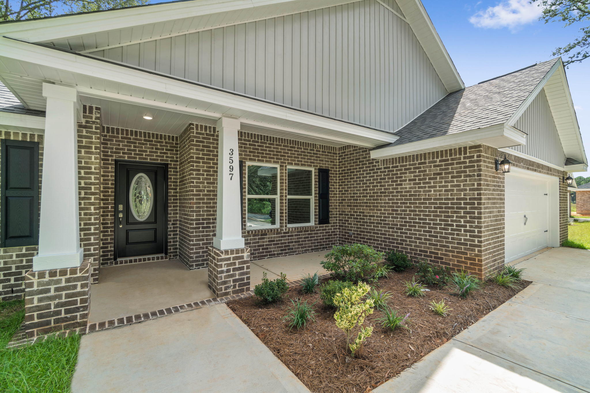 9158 Trident Road Milton, FL 32583 - Photo 1 of 41 a front view of a house with garden