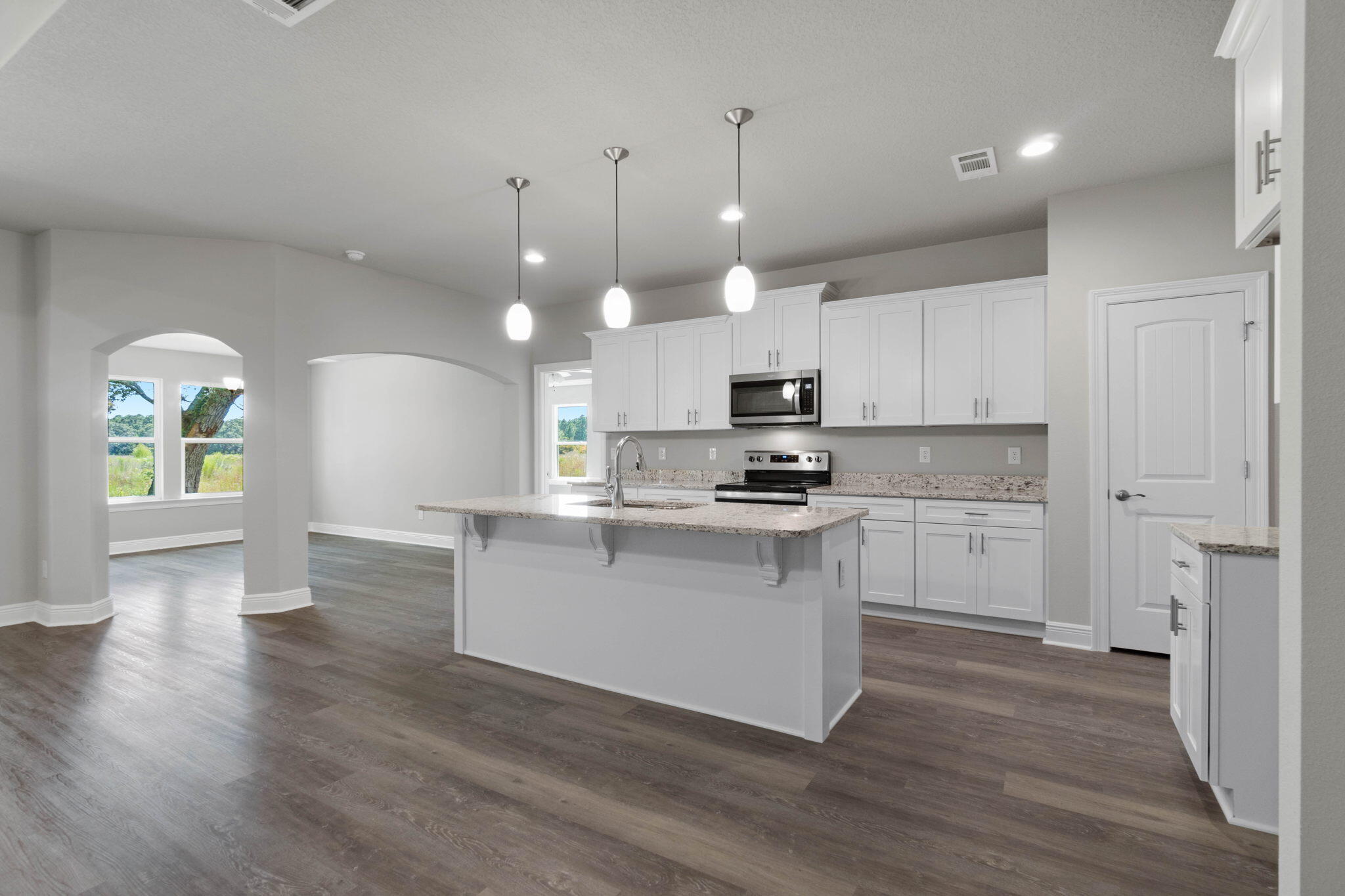 9158 Trident Road Milton, FL 32583 - Photo 11 of 41 a kitchen with white cabinets and stainless steel appliances