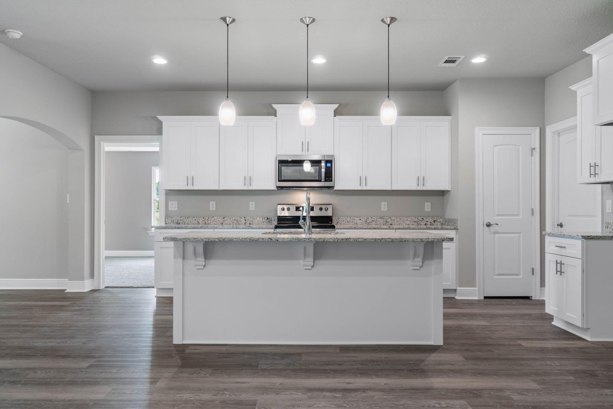 9158 Trident Road Milton, FL 32583 - Photo 12 of 41 a kitchen with kitchen island a sink stainless steel appliances and cabinets