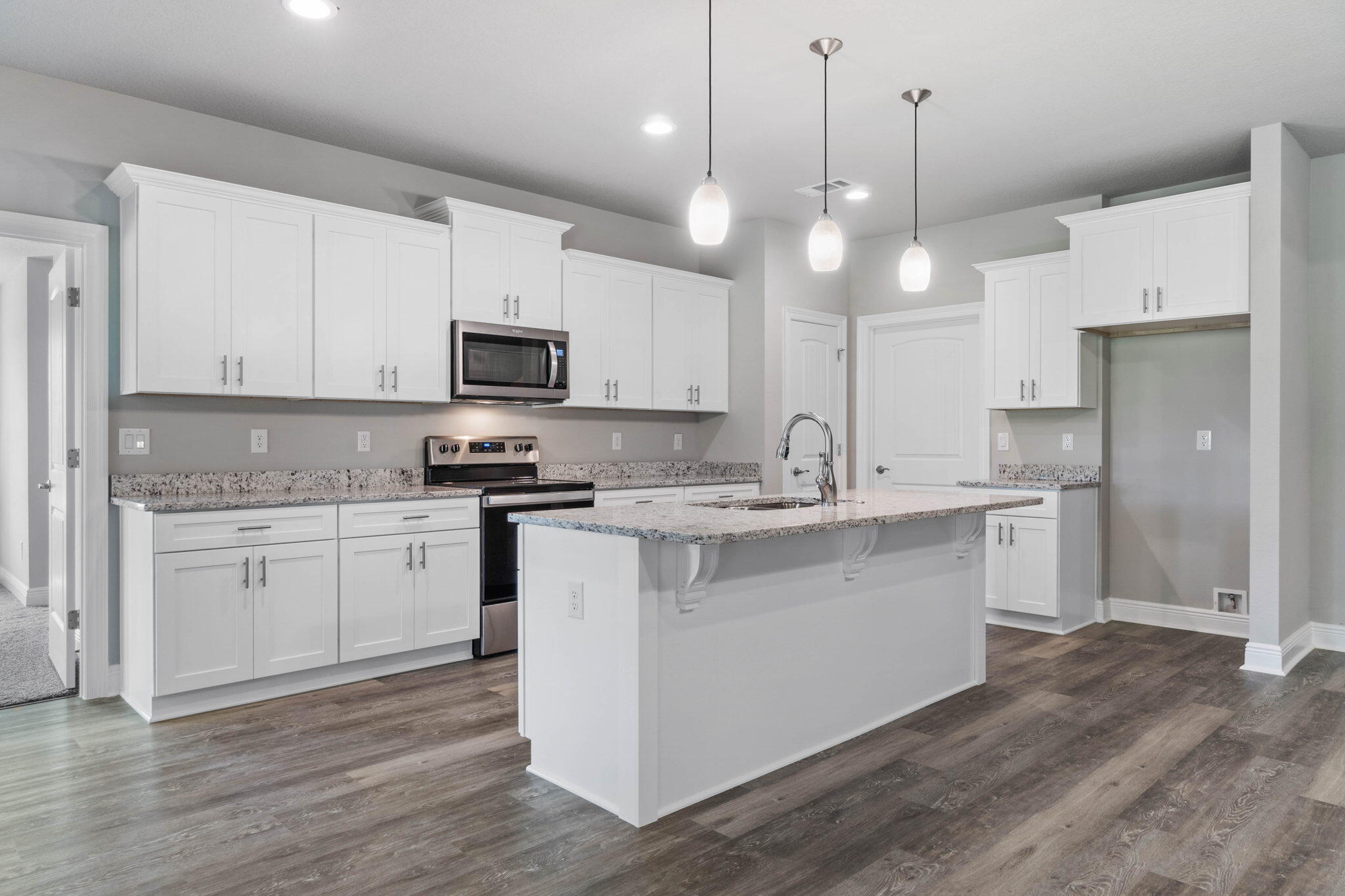 9158 Trident Road Milton, FL 32583 - Photo 13 of 41 a kitchen with a sink stove and microwave