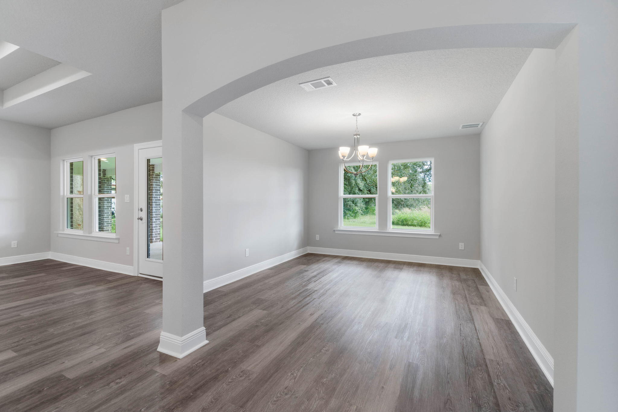 9158 Trident Road Milton, FL 32583 - Photo 18 of 41 an empty room with wooden floor and windows