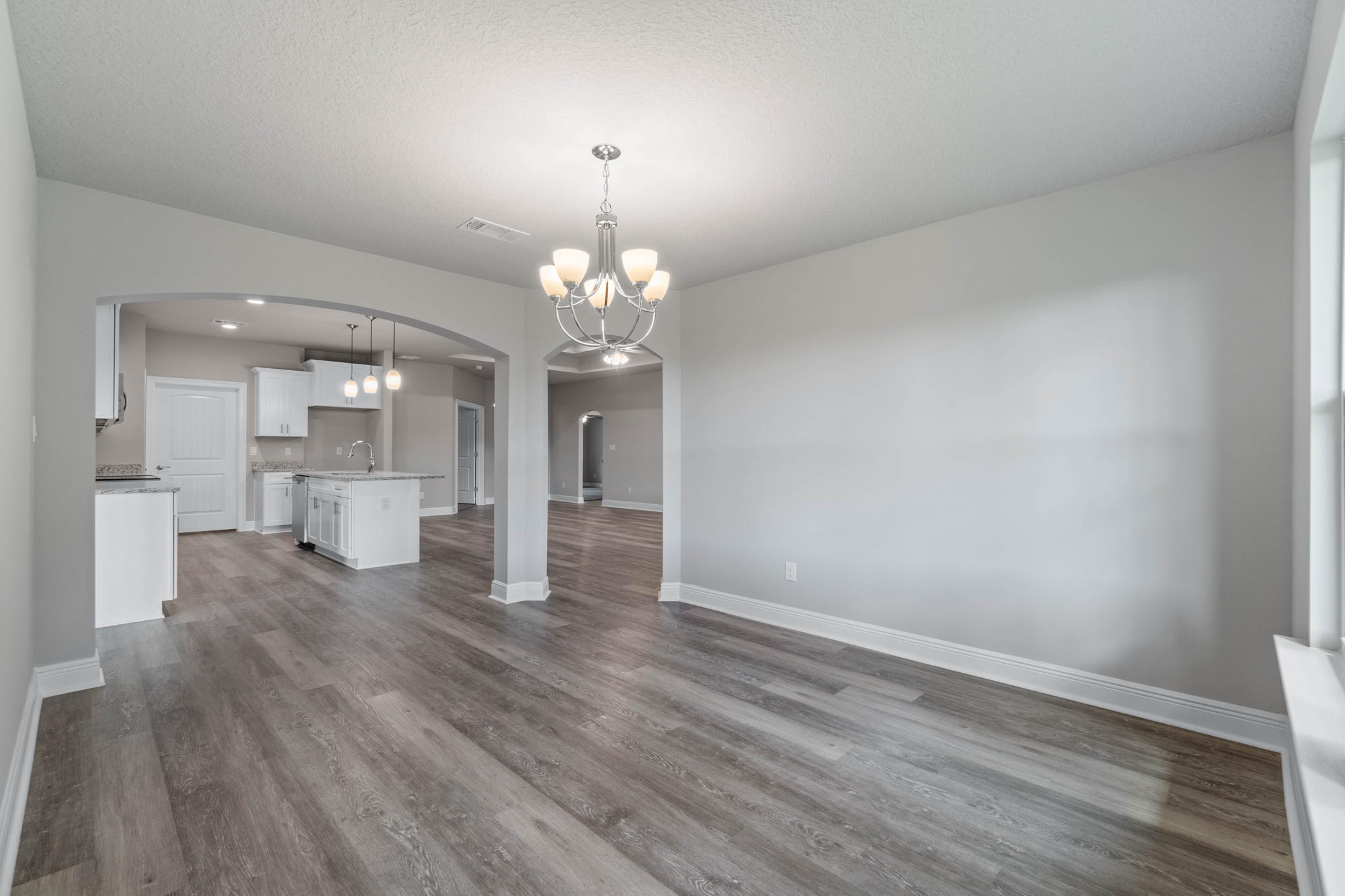 9158 Trident Road Milton, FL 32583 - Photo 19 of 41 a view of a big room with wooden floor