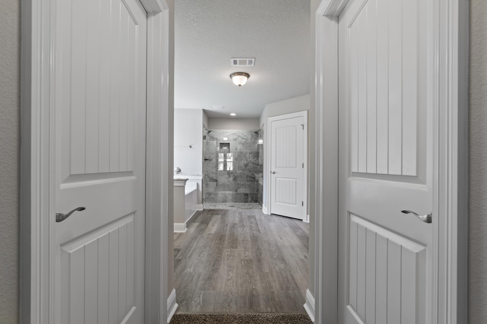 9158 Trident Road Milton, FL 32583 - Photo 22 of 41 a view of a hallway with wooden floor
