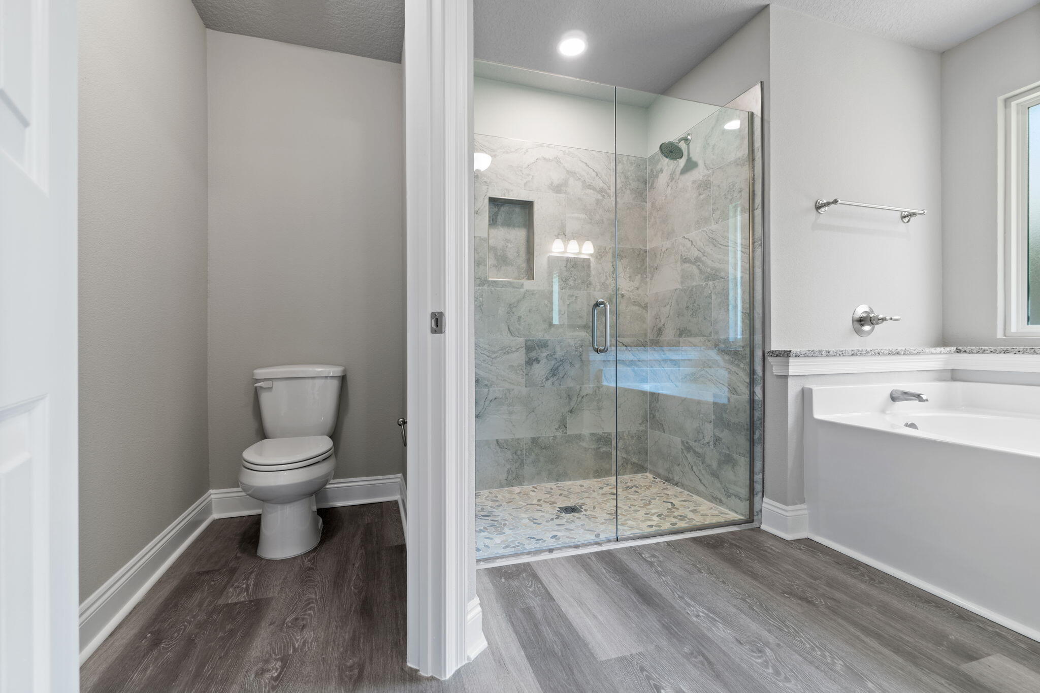 9158 Trident Road Milton, FL 32583 - Photo 28 of 41 a bathroom with a granite countertop toilet a sink and shower