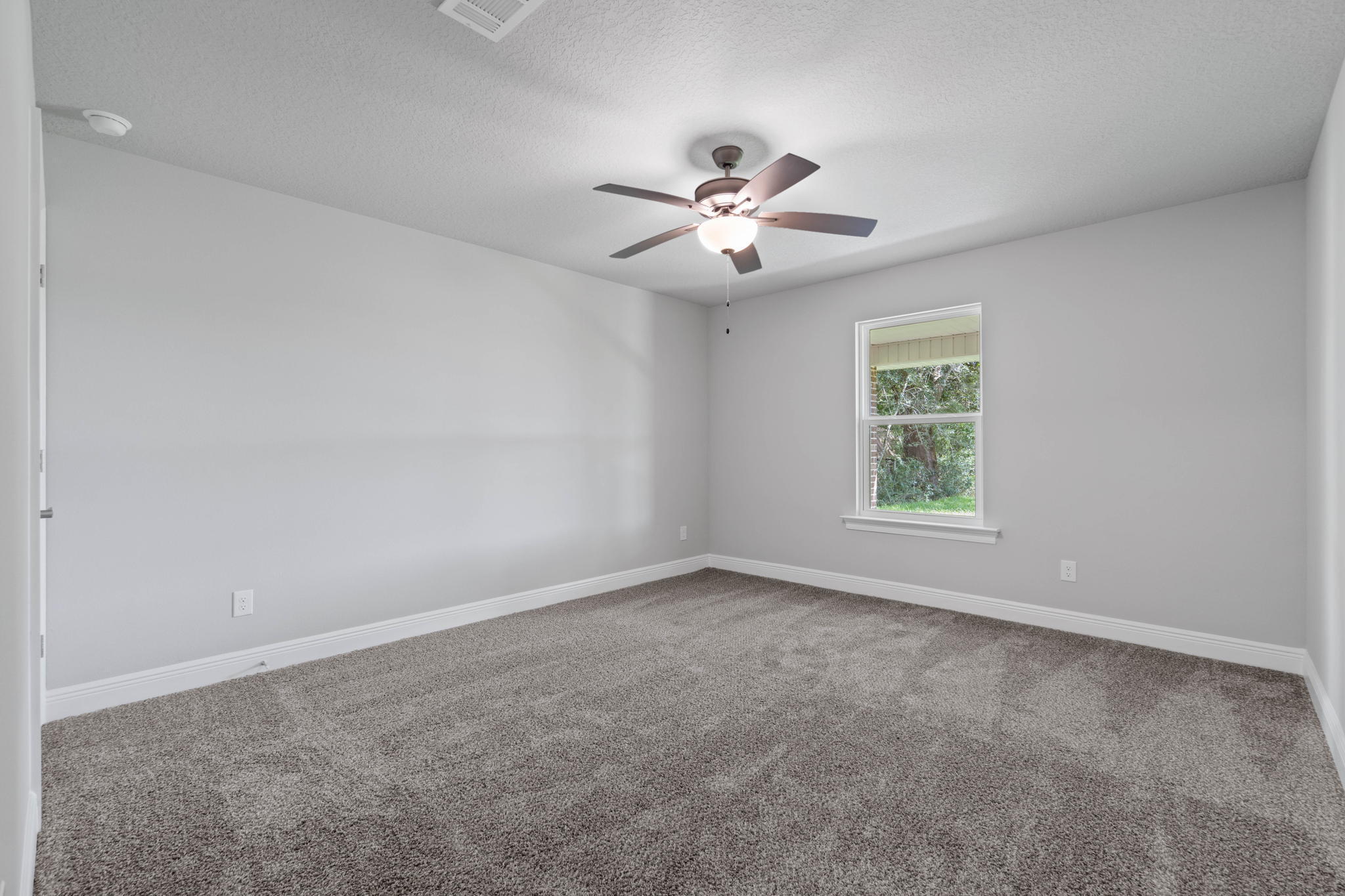 9158 Trident Road Milton, FL 32583 - Photo 32 of 41 an empty room with a window and a fan